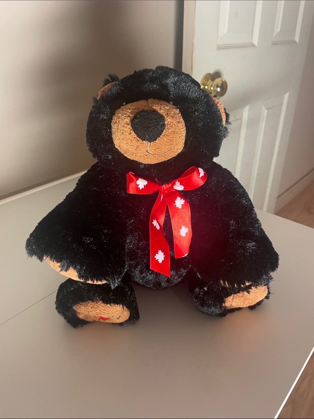 Plush Black Creature Comforts Teddy Bear with Red Maple Ribbon